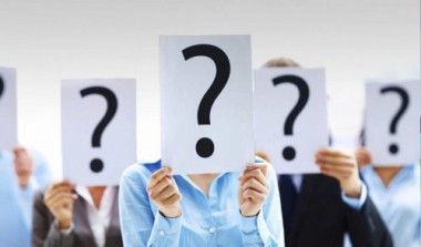 Picture of people holding up question marks over their faces.