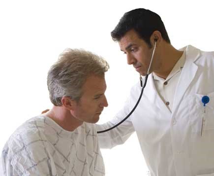 Male doctor with stethoscope examining male patient.